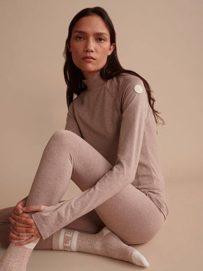 Taupe Marl|Always Warm Baselayer Top in taupe; made with Always Warm fabric, slim base layer with high neck, raglan sleeves, thumb holes, and right-arm patch.