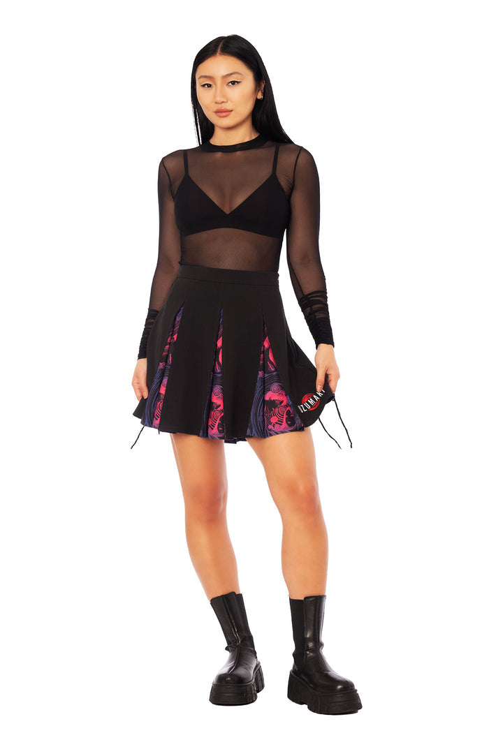 Uzumaki spiral print mini skirt from the Junji Ito x BlackMilk collection, high waisted black pleated skirt with layered manga artwork in gothic Japanese street fashion style.