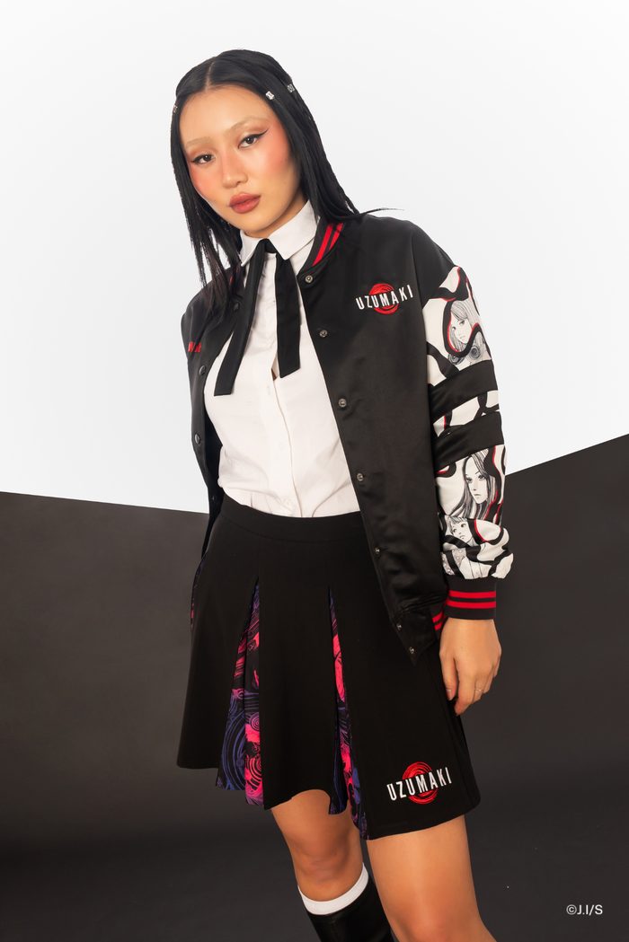 Uzumaki-inspired pleated mini skirt from the Junji Ito x BlackMilk collaboration, black zip front design with concealed spiral panels in dark alternative anime fashion.