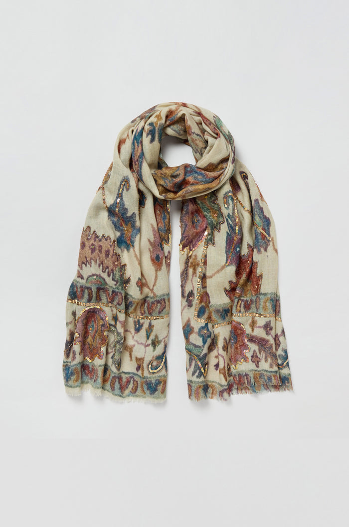 The Embroidered Tapestry Wool Scarf, crafted in light beige wool and silk, showcases a vibrant paisley and floral pattern with fringed edges and a soft, lightweight feel, displayed flat on a white background.
