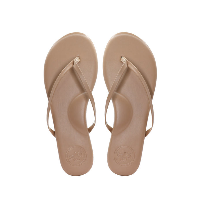 pair of beige thong sandals (flip-flops), top view showing toe-post straps