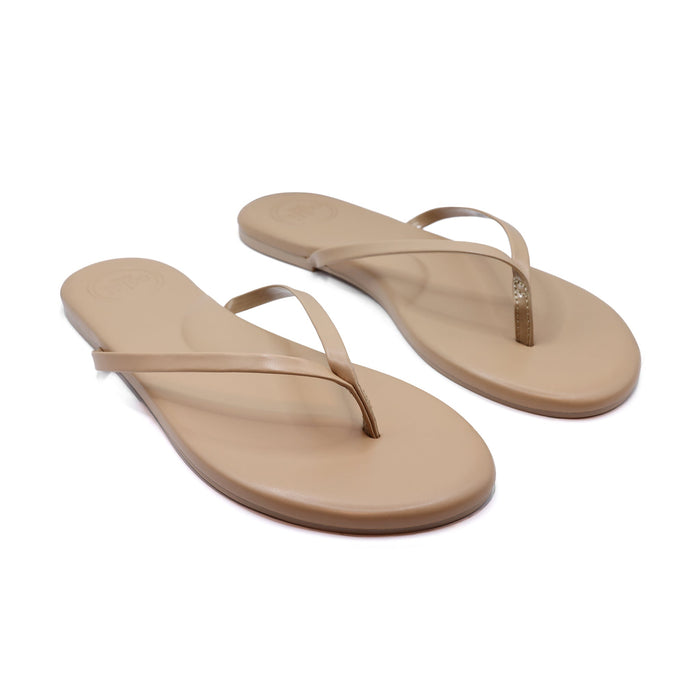 Tan flip-flop sandals with slim toe-post straps and lightly cushioned footbed, angled view.
