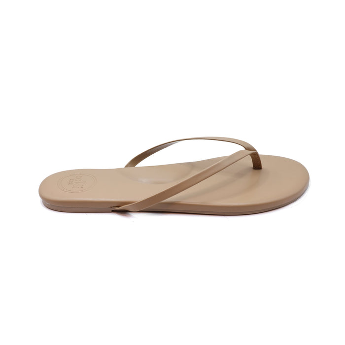 Beige thong flip-flop sandal with thin straps, side view on white background