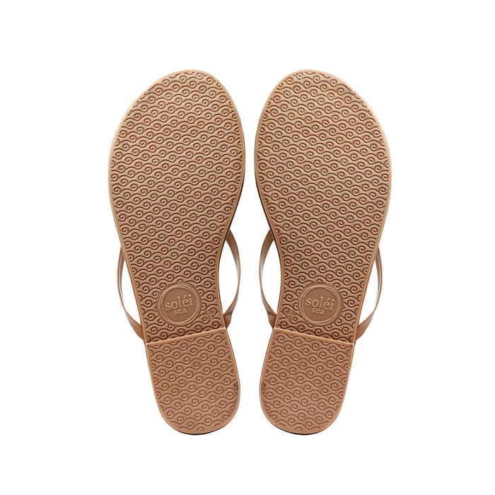 Bottom view of INDIE - CAFE by Solei Sea flip-flop sandals showcasing wave-patterned non-slip rubber soles on a white background