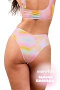 Front view of Jennings V-Cut High-Waisted Bikini Bottom in pastel tie-dye with V-front and onewith Claire Buckley overlay