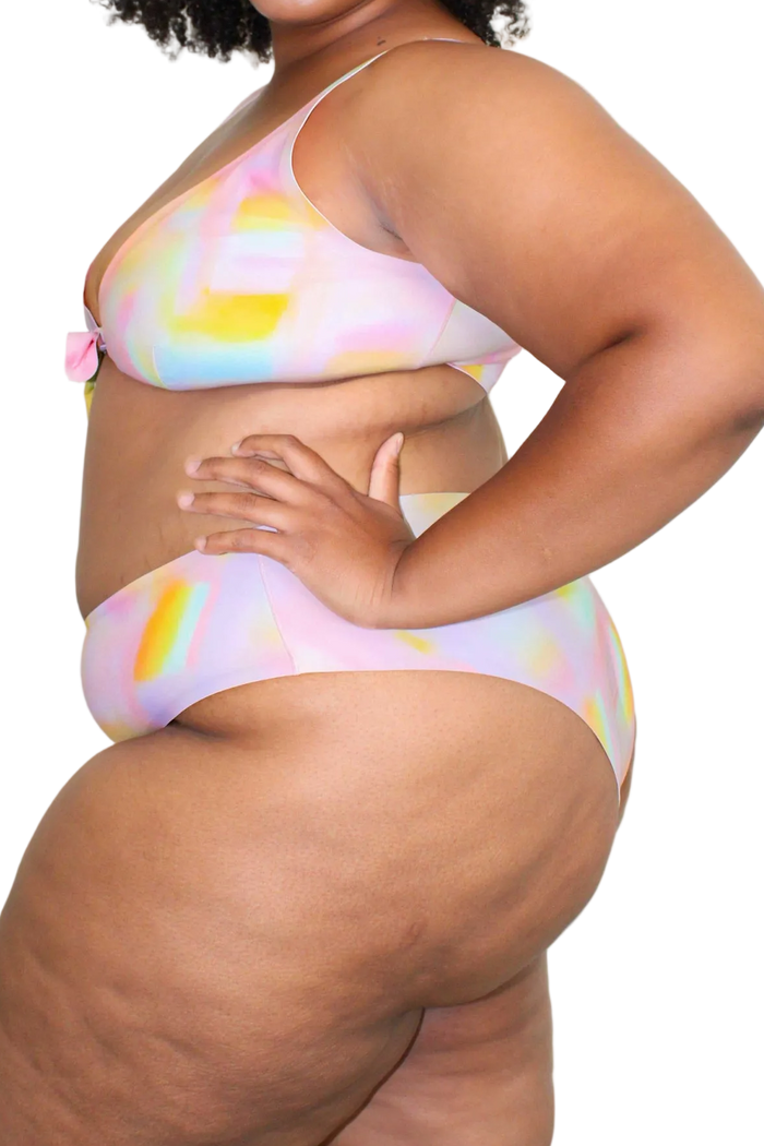 Side view of Jennings V-Cut high-waisted bikini bottom on model showing high-rise fit and seamless edges in pastel tie-dye | nesharae__/ 2XL + 3XL