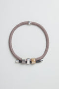 The braided bracelet with silver and gold-tone beads pairs beautifully with the Layered Marble Bead Cord Necklace for an elegant, coordinated look.