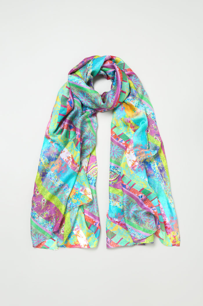 The Archival Stripe Silk Scarf is a lightweight accessory with an abstract pattern in turquoise, pink, yellow, and green, shown flat on a light background.