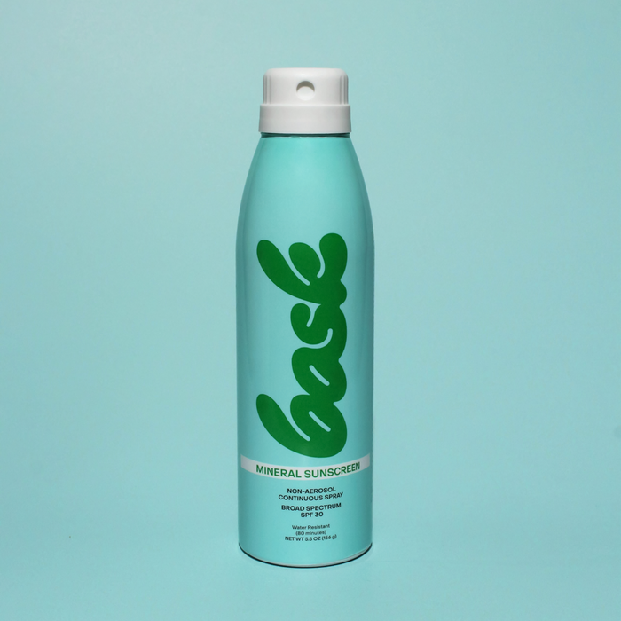 Front view of Bask SPF 30 mineral non-aerosol spray can showing large green bask logo on mint background