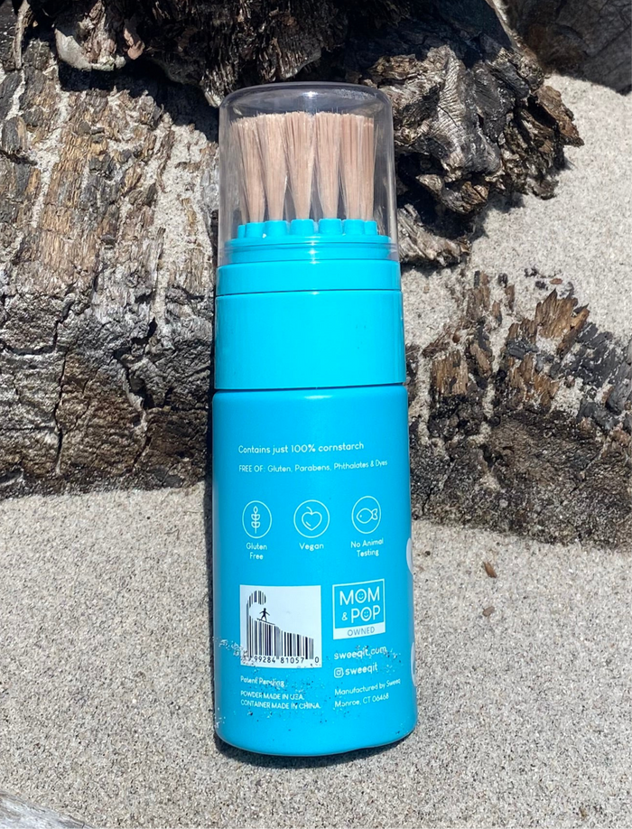 Blue sand remover with bristles on a rocky surface