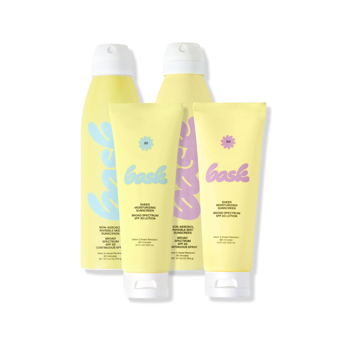 Front view of The Core Four sunscreen bundle with SPF 30 and 50 lotions and non aerosol sprays on a black background