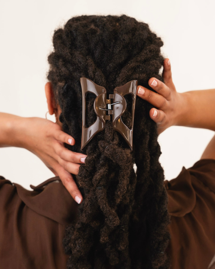 Rear view of person with long hair pulled back with a Cozy Clip hair clip